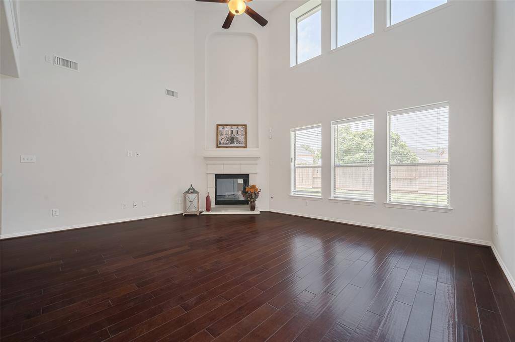Sunlight pours through large windows, highlighting the spacious living area and creating a serene, bright environment.