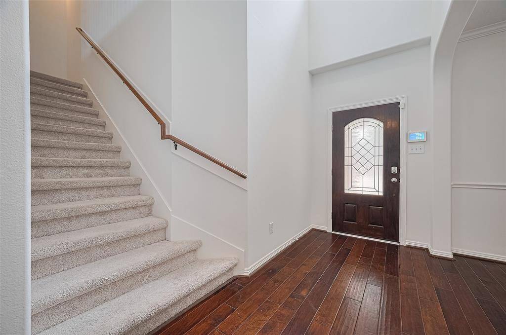 Light-filled stairwell connects both levels.