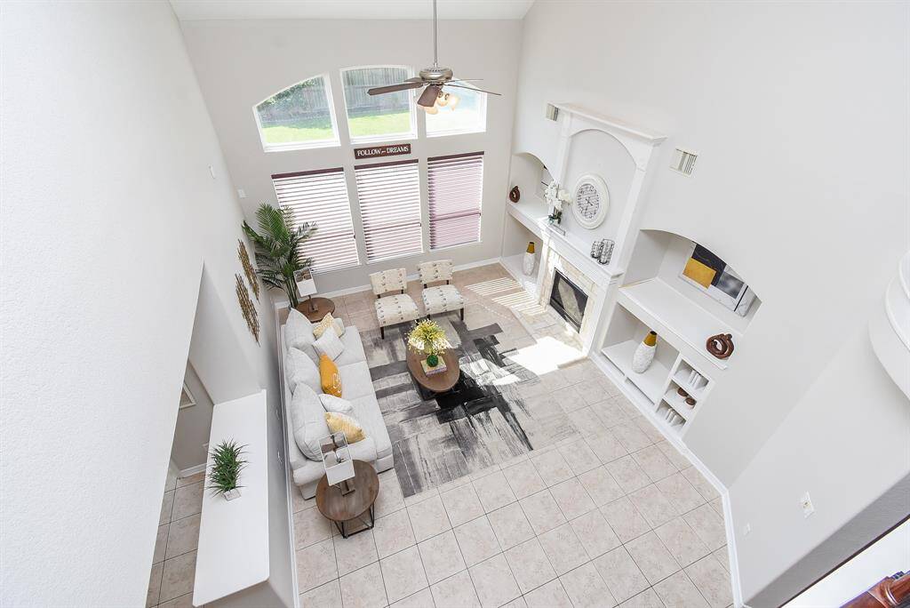 From above, the view over the living room highlights the scale and openness of the home, with tall ceilings and flowing sightlines to the front entry. A beautiful example of the home's interconnected layout.