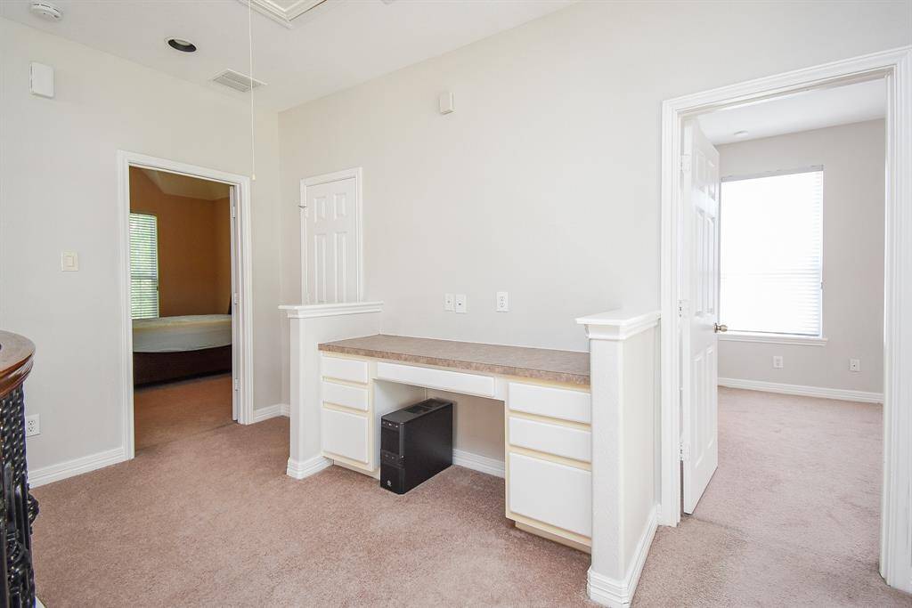 A thoughtfully designed built-in desk area provides a perfect nook for studying or remote work. Tucked into the upstairs hall, it adds utility without sacrificing aesthetics.
