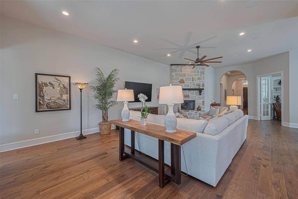 This is a view of the family room looking back towards the front entry - I want to draw your attention to the dedicated home office tucked behind elegant French doors—a perfect space for work or study.