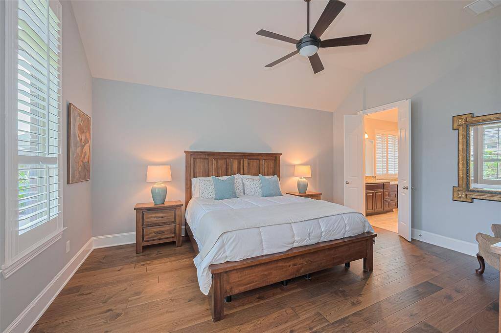 Throughout the home, plantation shutters lend an elegant and timeless sophistication to every room - and they offer additional privacy here in the primary bedroom
