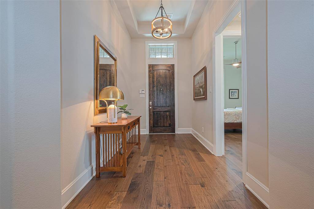 Step through the inviting front entry into this beautifully updated home, where recently installed wood flooring extends throughout the entire space, excluding bathrooms. A neutral color palette enhances the warm, modern feel—making this home completely move-in ready!