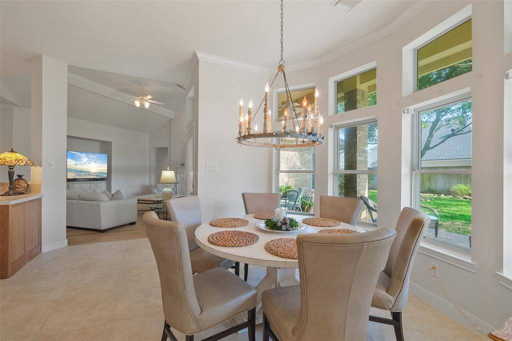 A CUSTOM CHANDELIER ANDA BEAUTIFUL VIEW OF THEBACKYARD.