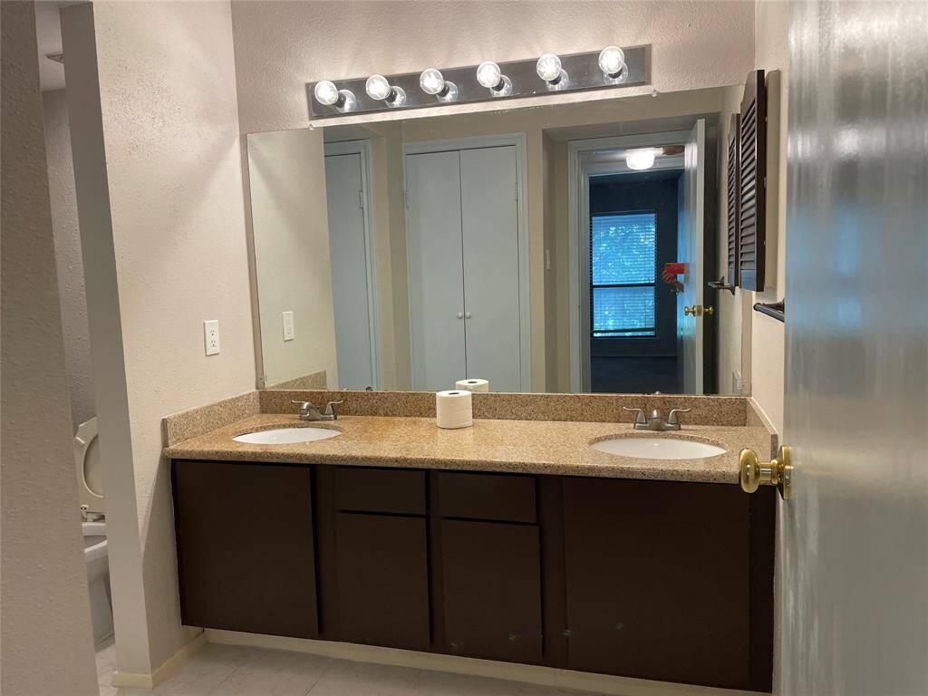 The bathroom features double sinks for added convenience.