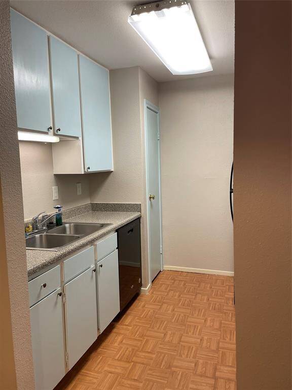 The other side of the kitchen features plenty of cabinet space for ample storage.