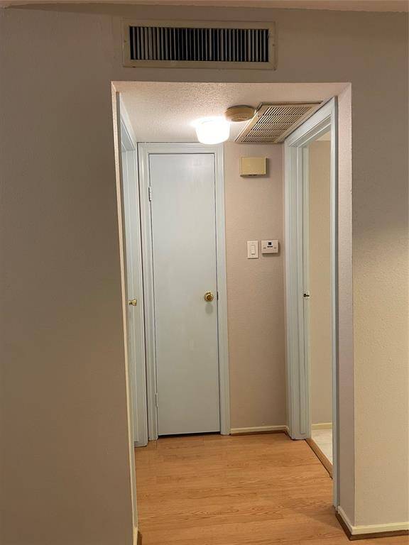 View from the back of the front door: the bedroom is to the left, the bathroom is to the right, and a closet is straight ahead.