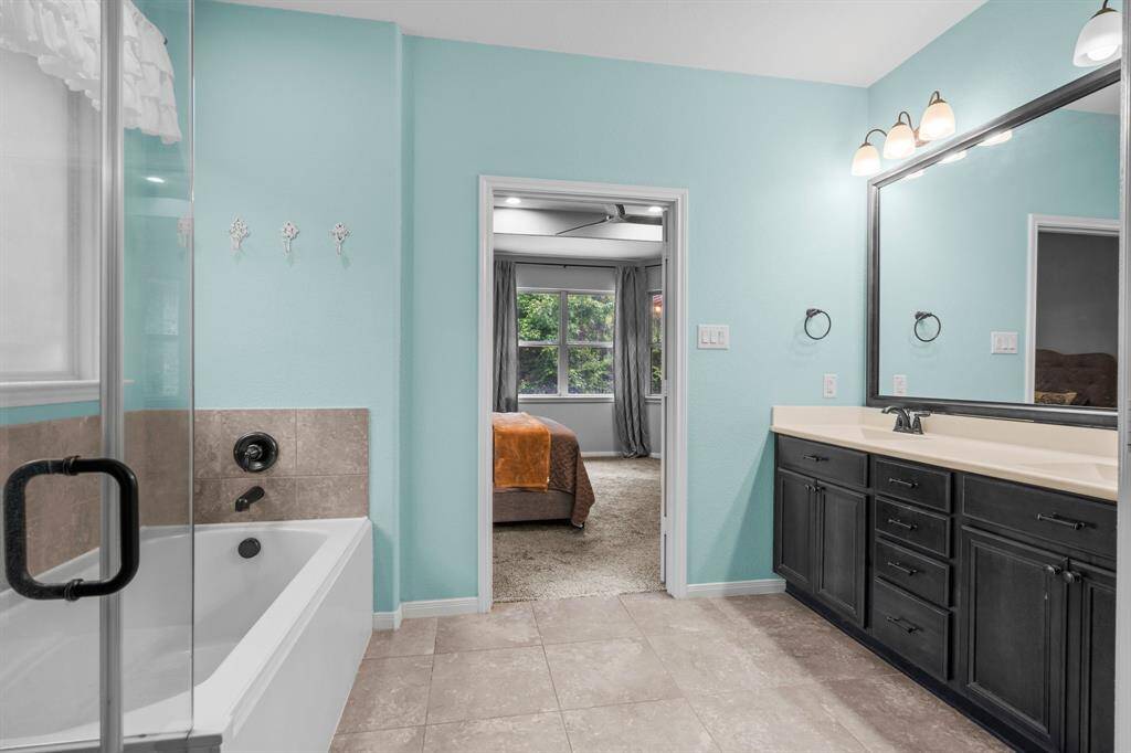 Your Owners’ en suite is a tranquil retreat designed for ultimate relaxation. The deep soaking tub is the perfect spot to unwind, while the expansive shower offers a refreshing experience. A rainglass window allows natural light to filter through, creating a bright and airy ambiance. Dual sinks and private commode elevate the space to a level of comfort and luxury.