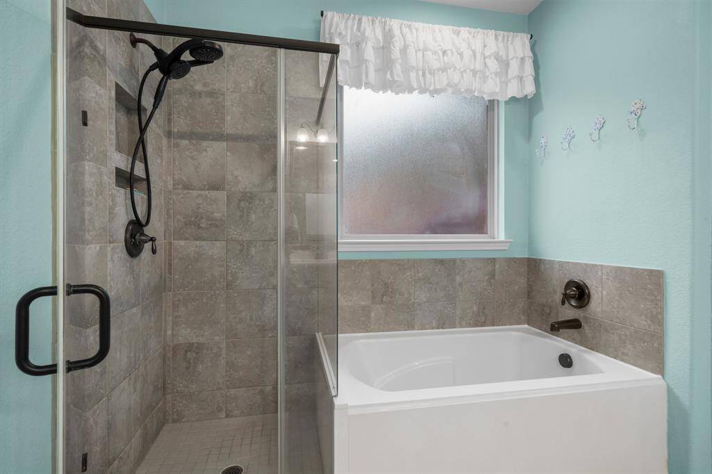 Unwind in the tastefully designed spa-like Owners’ bath. The soaker tub is ideal for relaxing, and the large shower with two built-in toiletry niches and two shower head options is perfect for an invigorating wake-up in the morning. A large window with rain glass insert allows natural light to fill the room while maintaining your privacy.
