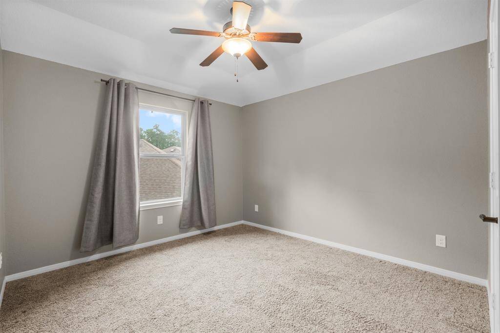 This secondary bedroom offers lush carpeting, sloped ceiling, walk-in closet, sunny window, and lighted ceiling fan.  It has hallway access to a full bath shared with Bedroom 3.