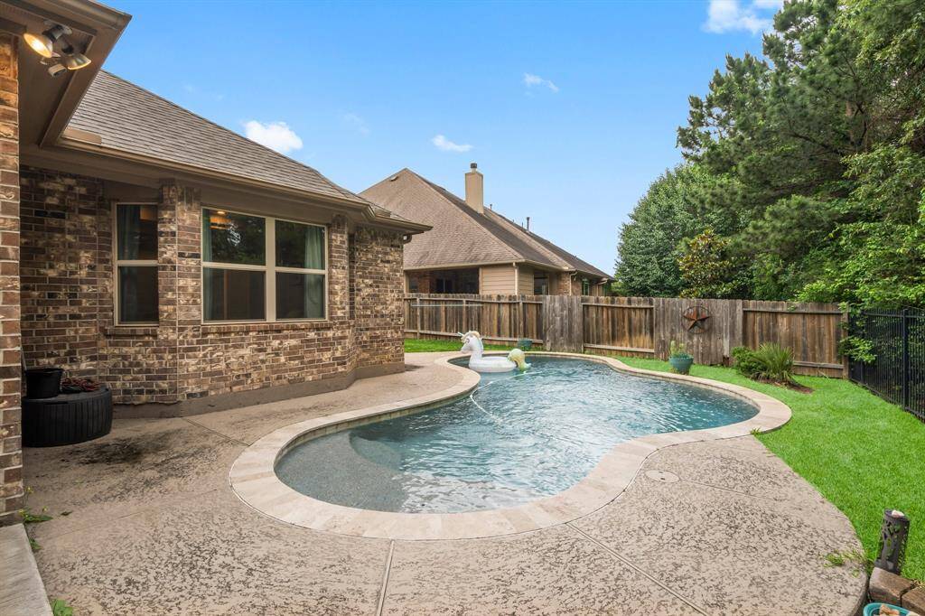 Step into your own private paradise—this backyard oasis feels like a vacation every day. The sparkling pool features a Baja sun shelf with an umbrella port, perfect for lounging in the shade while staying cool in the pool. Everything you need to relax, unwind, and enjoy life is right here!