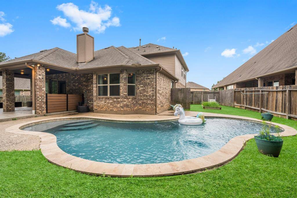 Before heading inside, take a moment to enjoy a sneak peek of the stunning backyard! You'll find a spacious covered porch leading to a 23' x 22' extended patio with hand-troweled concrete flooring—perfect for outdoor entertaining. The sparkling pool offers a refreshing escape during hot summer days, while the generous greenspace provides plenty of room for play and relaxation. This outdoor retreat is ideal for both lively gatherings and quiet moments.