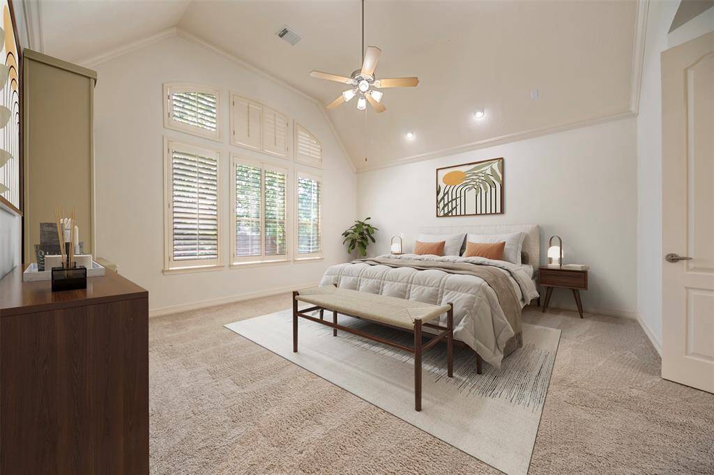 The spacious primary bedroom offers a serene retreat with ceiling-mounted reading lights on either side of the bed, creating a cozy and functional space for relaxation.(This photo is virtually staged)