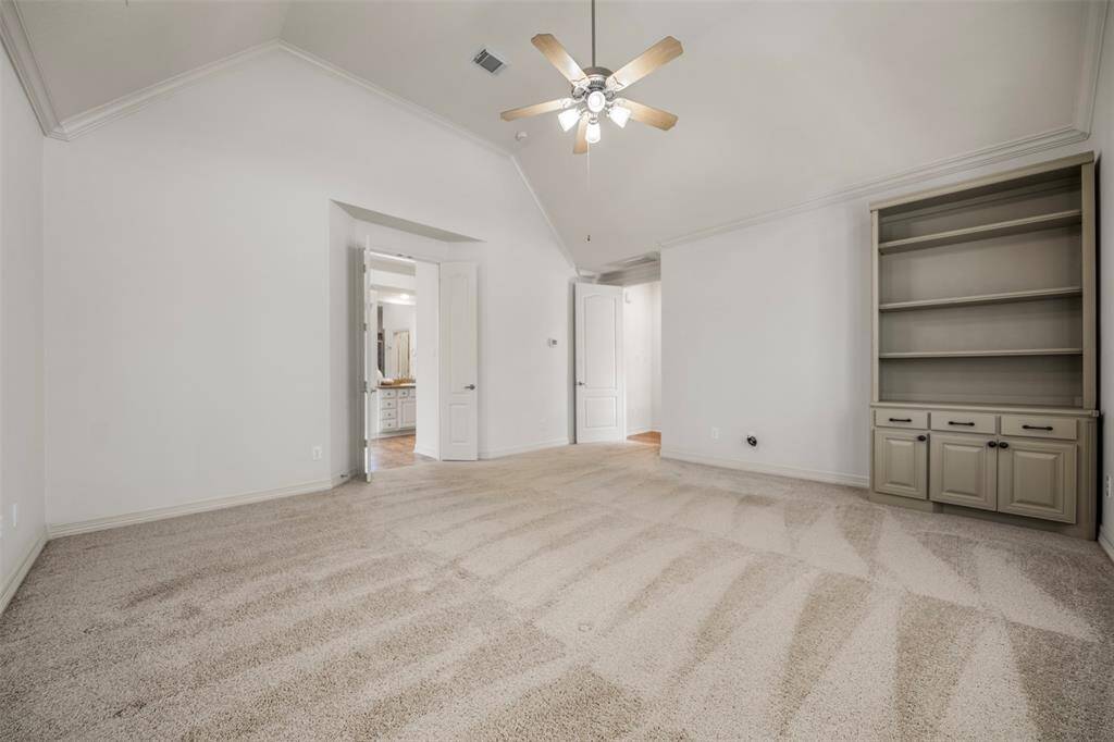 The large primary bedroom exudes comfort and elegance, with French doors that lead gracefully into the en-suite bath, adding a touch of charm and architectural sophistication to the space.