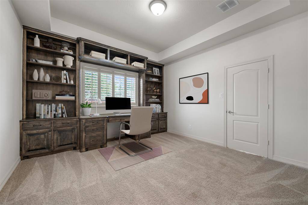 French doors open into the luxurious office, featuring a custom-built desk and expansive shelves for sophisticated storage. A separate door leads to the secondary bedroom and its beautifully appointed full bath.(This photo is virtually staged)
