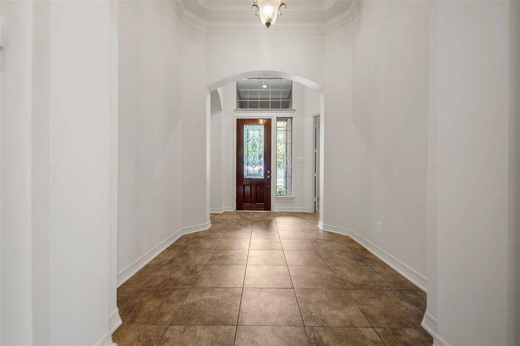Step into a grand formal entry with soaring ceilings, and a statement chandelier, that sets the tone for the rest of the home.