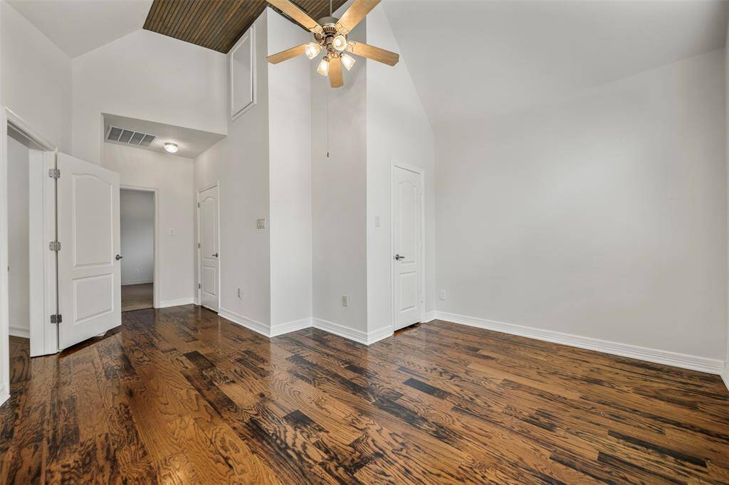 The secondary bedroom features a stunning wood ceiling that adds warmth and character to the space. It offers seamless access to the office, as well as an en suite bath, creating a perfect balance of privacy and convenience.