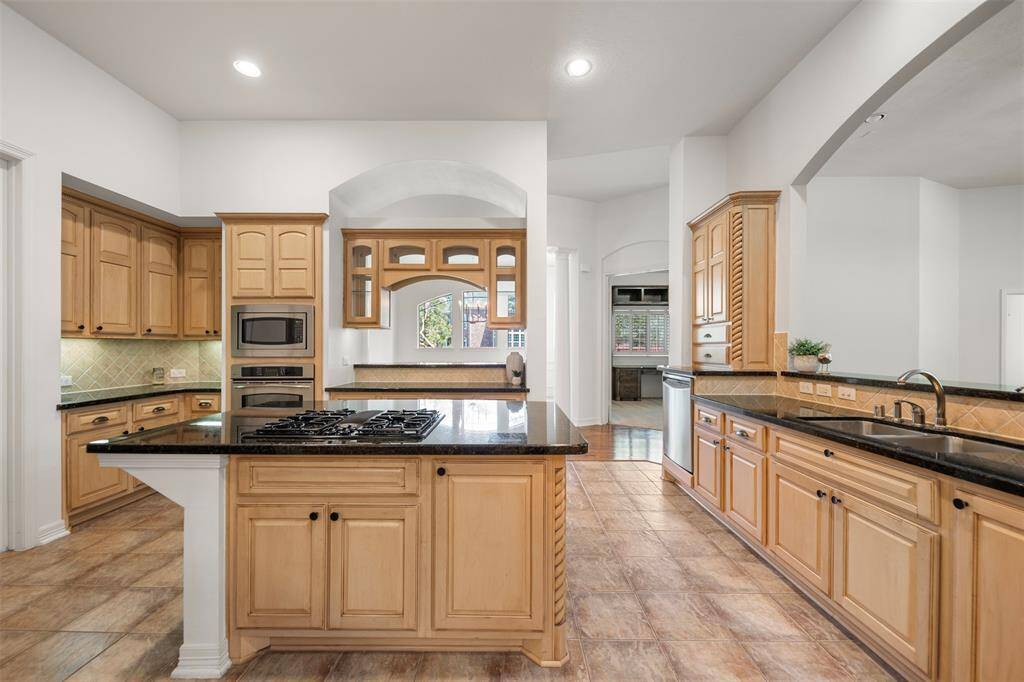 The kitchen boasts granite countertops, custom cabinetry, and an abundance of counter space—perfect for cooking, hosting, and everyday living.