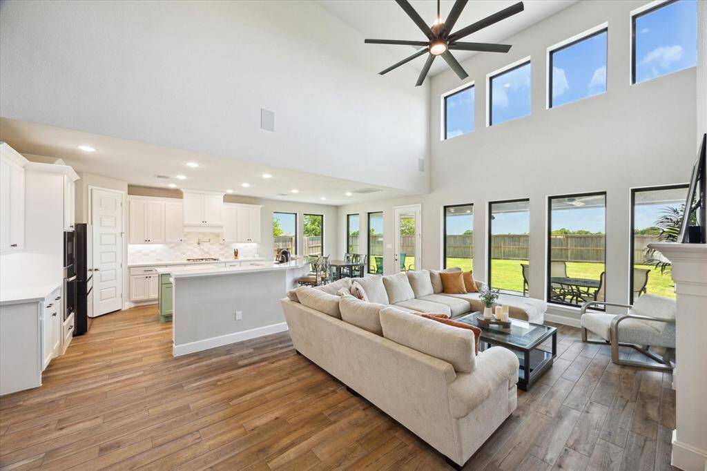 A wall of windows baths the family room in natural light.