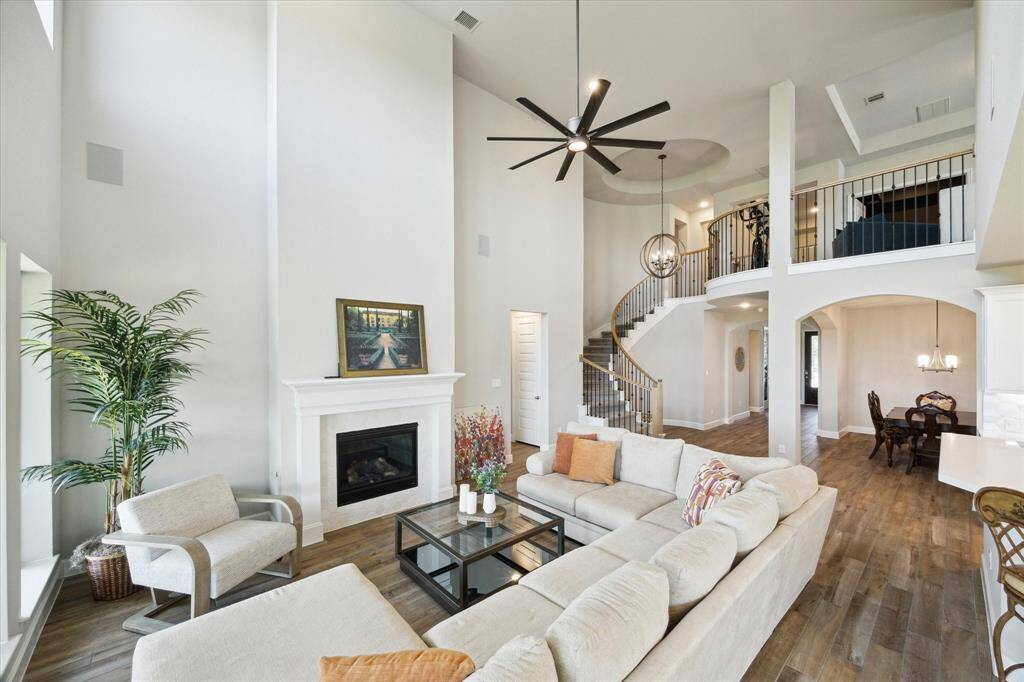 An open floor plan and extensive wood tile flooring.