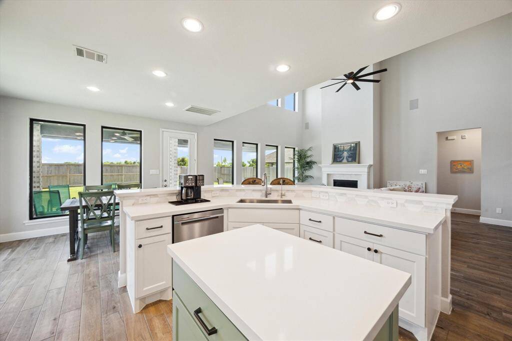 Gorgeous white quartz countertops prevail in this well-designed kitchen.