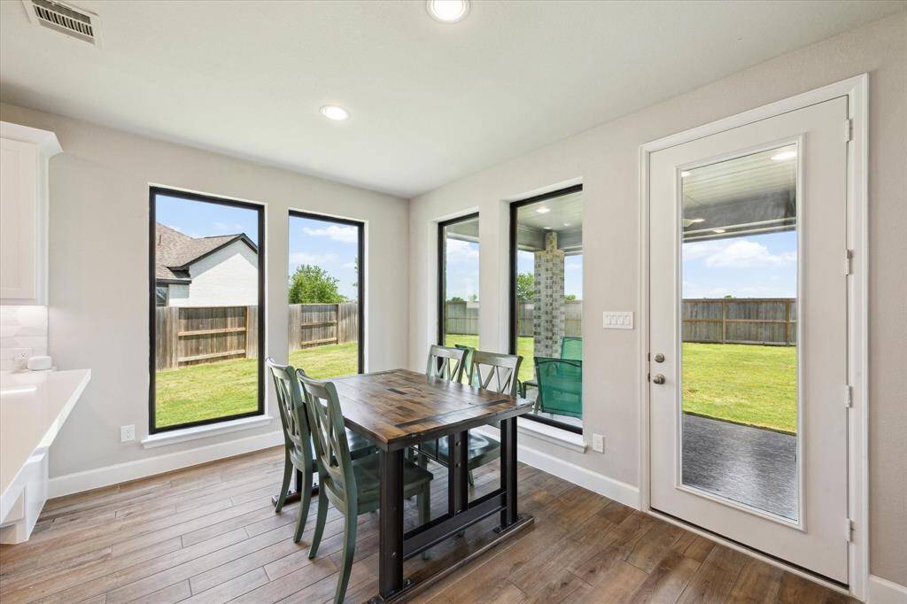 The cozy breakfast area overlooks the back covered patio and lawn. A perfect spot for your morning coffee.