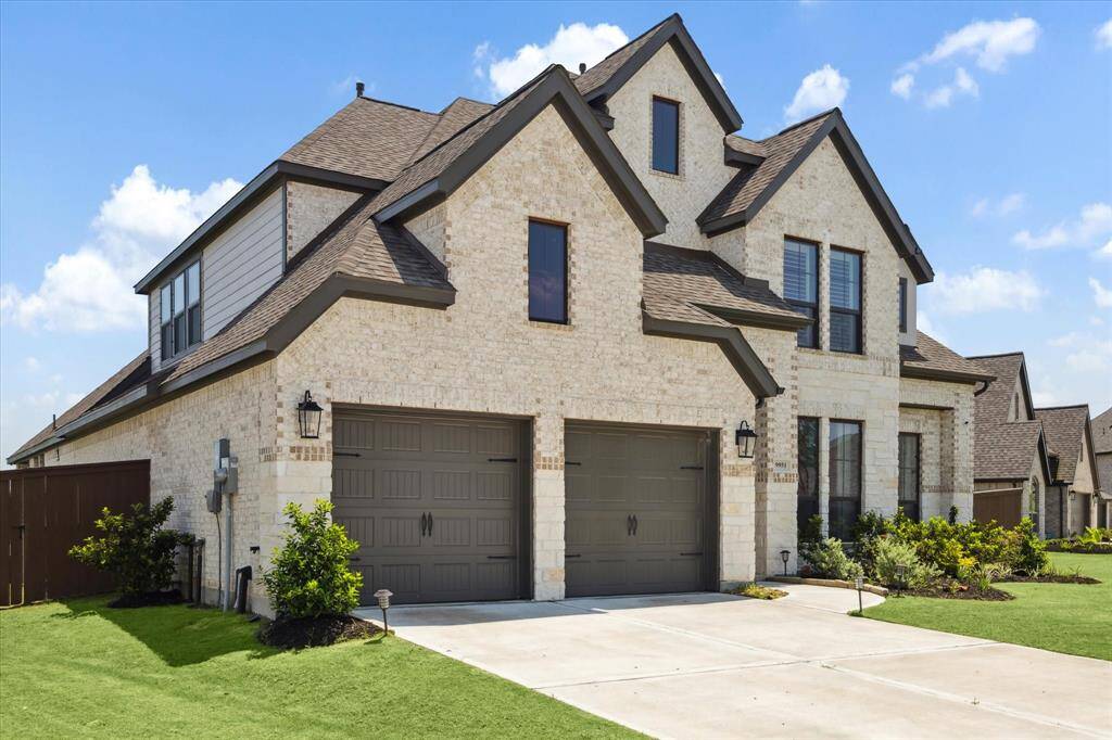 A double wide driveway leads to the 3 car tandem garage.