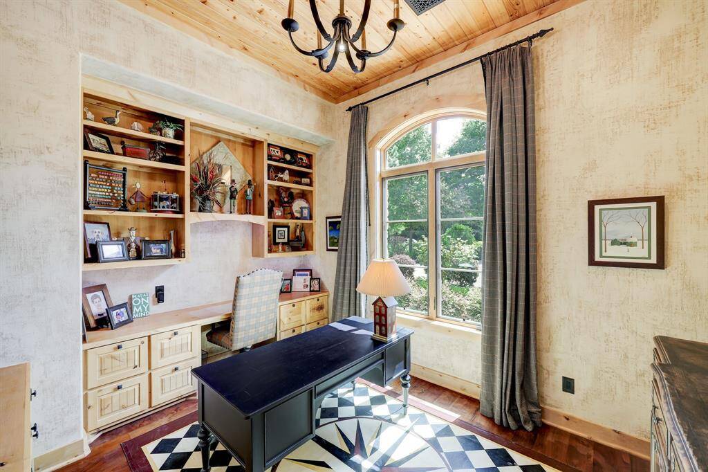 The second study or library includes built in shelving and beautiful natural lighting.