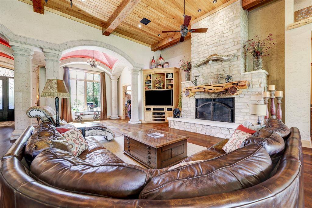 The oversized stone fireplace and cedar mantle provide a stunning focal point of the living room.