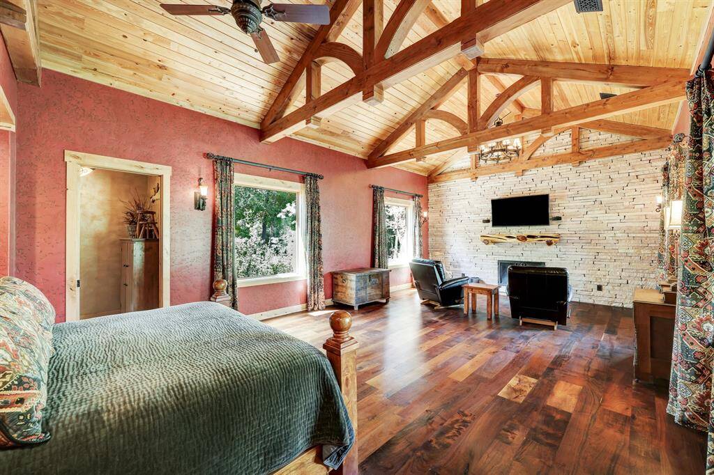 The primary suite includes exceptionally high ceilings, arch work, and a seating area.