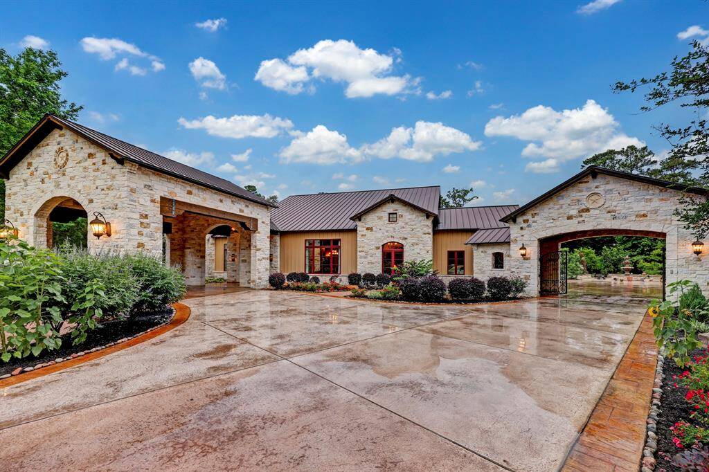 The rustic stone exterior and bountiful flora transports you to your own ranch style living!