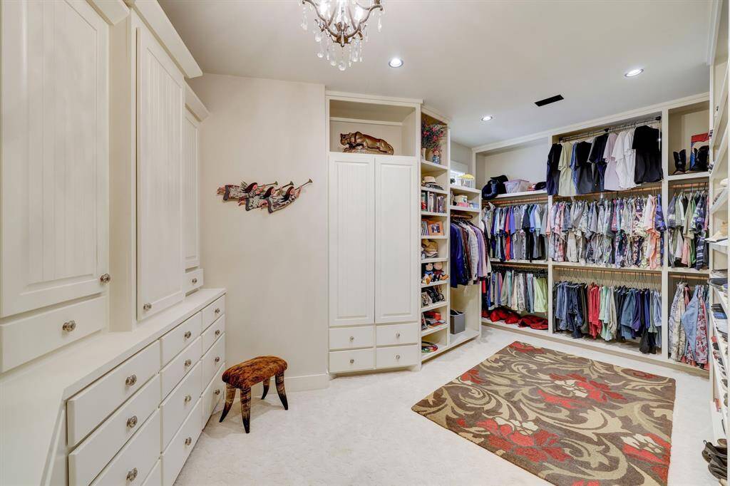 One of two oversized closets with built in drawers and shelves, specific cedar cabinets, and floor to ceiling shoe rack.