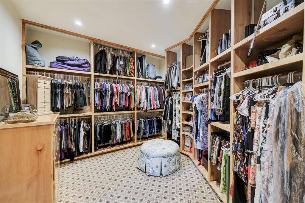 One of two oversized closets with built in clothing racks and drawers.