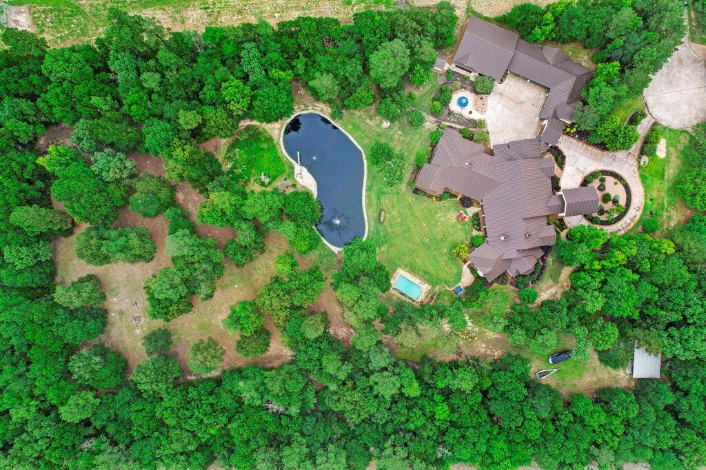 The lot includes professional golf grass in the immediate backyard and additional wooded acreage.