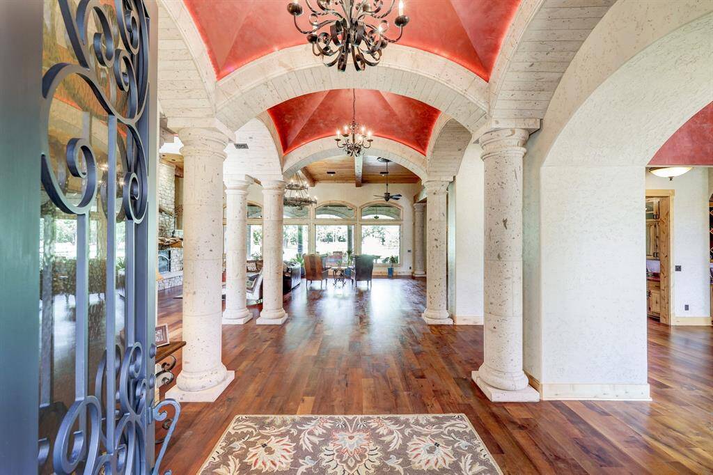 The foyer includes an abundance of custom imported Canterra columns and opens up to several main rooms of the home.