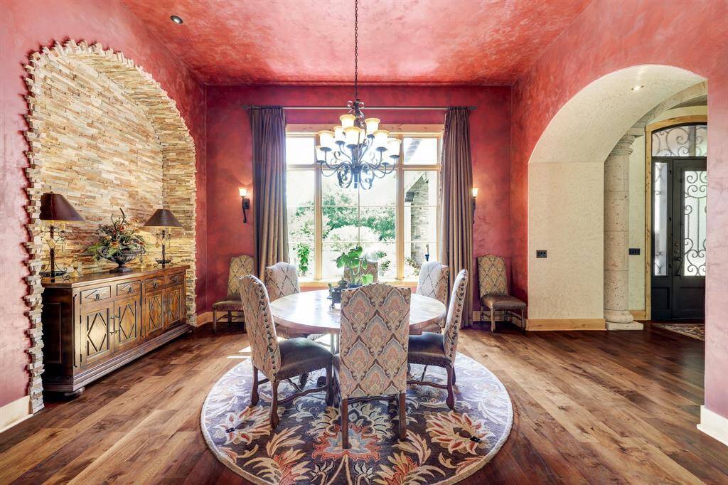 Right off the main entrance, the formal dining room has a built in stone nook and oversized windows that look to the front yard.