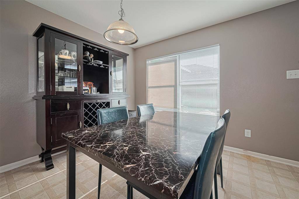 The dining room has a large picture window and overhead light fixture.