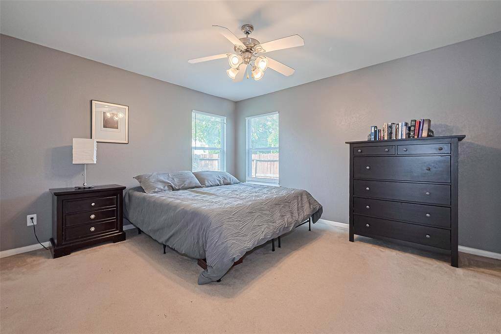 The primary bedroom has a ceiling fan with light kit.