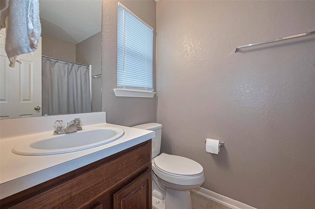 The 5x7 SF primary bath has a tub/shower combo with tile surround.