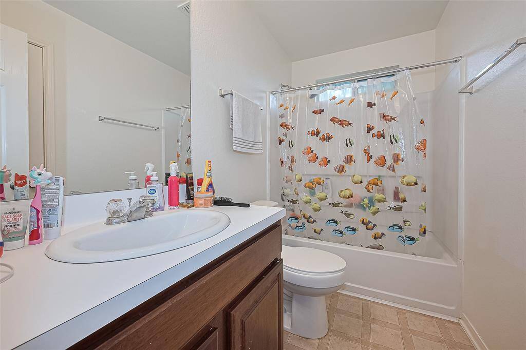 The 5x8 SF 2nd full bath has a tub/shower combo with tile surround.