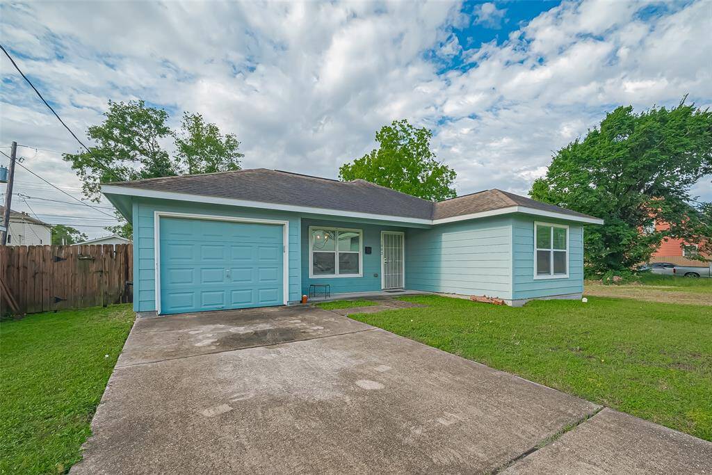 The home has a 1 car garage and long driveway for additional parking.