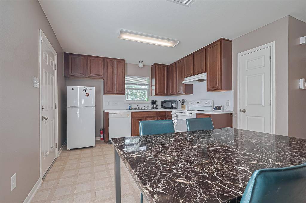 The 9x11 SF kitchen has ample cabinet space, a fridge, stove, dishwasher & pantry.