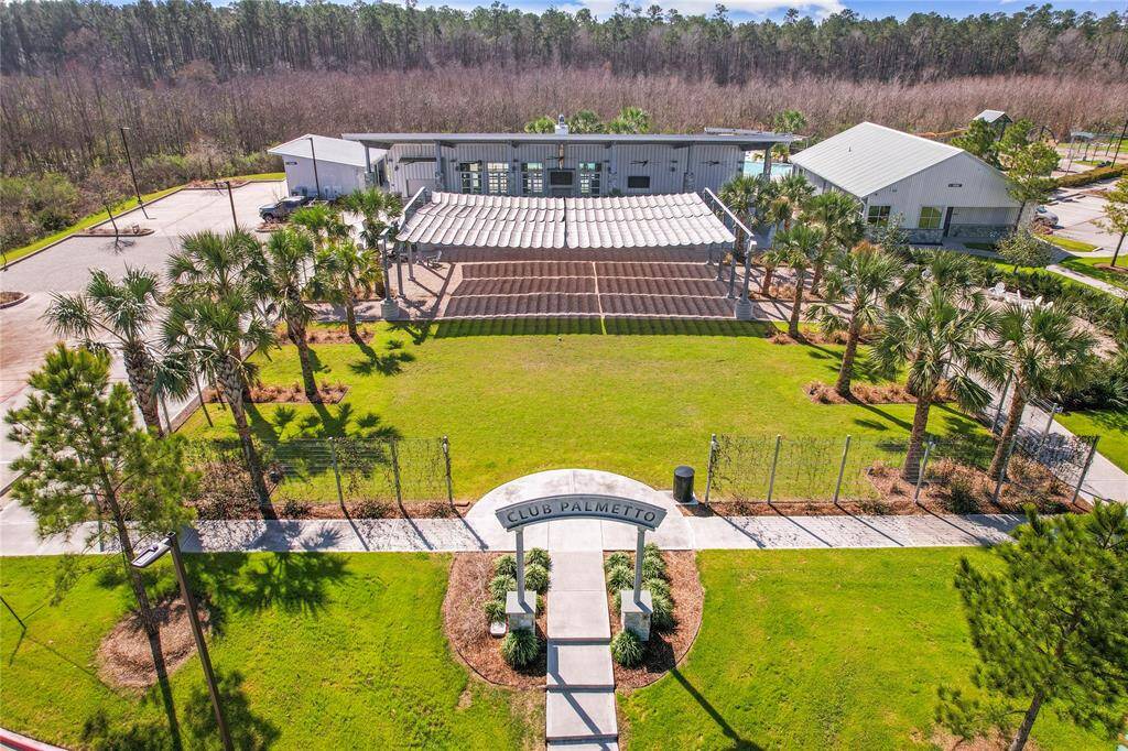 View of the nearby Palmetto Club, part of the pool recreational facility. The HOA has a representative on staff here every day!