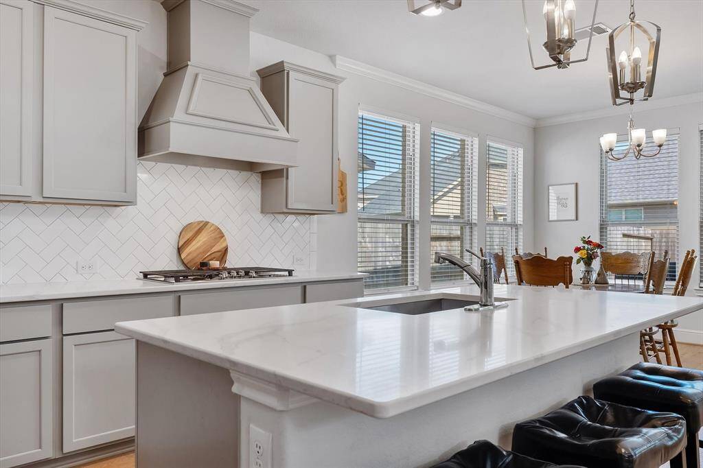 Gourmet chef's kitchen with soft close cabinets, stylish range good and serving island
