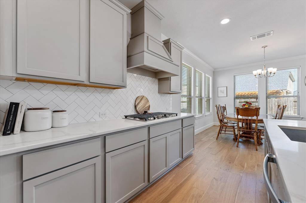 Gourmet chef's kitchen with soft close cabinets, stylish range good and serving island