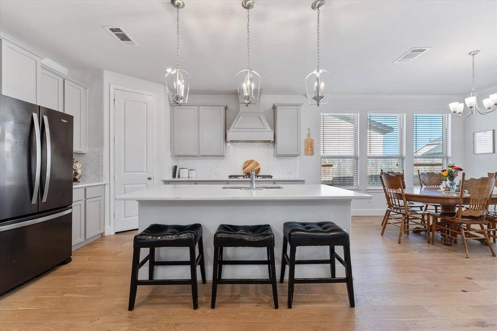 Gourmet chef's kitchen with soft close cabinets, stylish range good and serving island