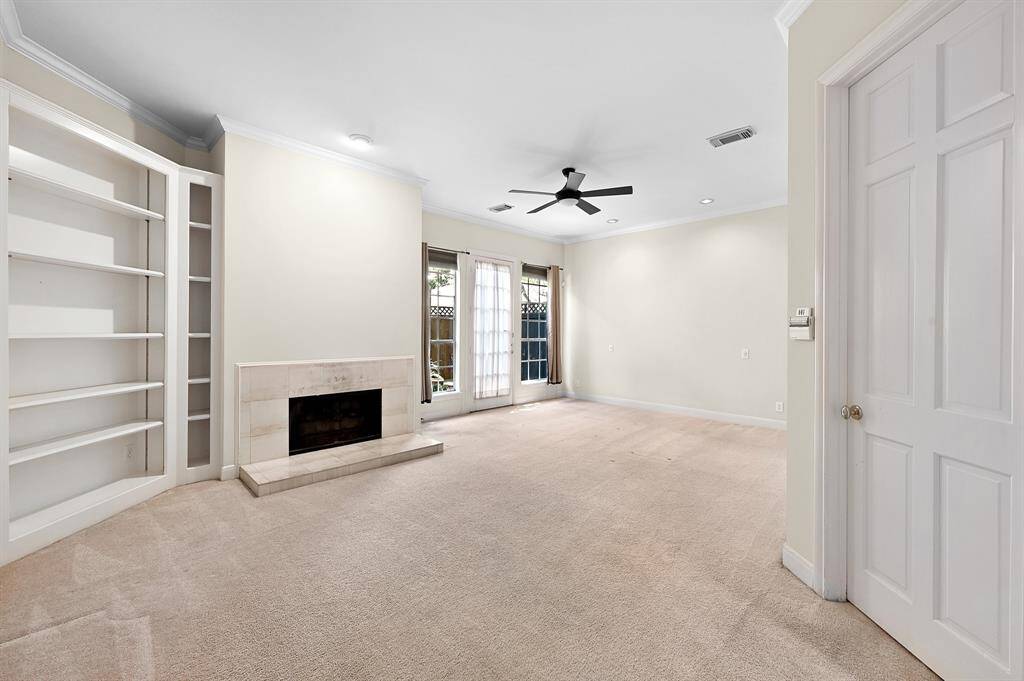 Spacious primary bedroom boasts fireplace and private patio doors which lead to the private oasis!