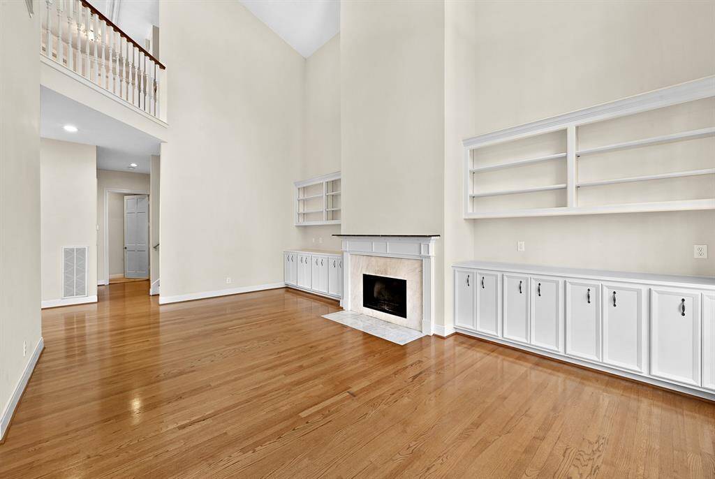 Gorgeous living area as soon as you walk in! fireplace, custom built-ins and opens into the formal dining and kitchen!