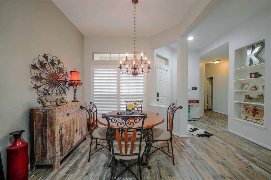 View of dining area table, distressed buffet and decor.