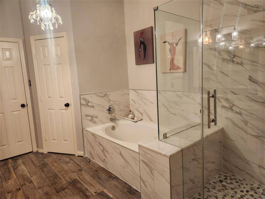 Recently updated master bath features granite, vessel sink and upgraded lighting and a large walk in closet. Notice shower has a seat in it.
